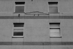 A smiling crocodile, painted at a wall between windows.