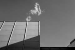 Rectangular building wall with a small cloud above it