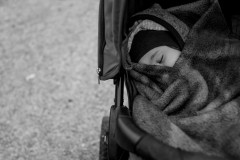 Lumi sleeping, wrapped in a blanket in her stroller