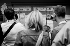 Attendees taking photos of the session schedule