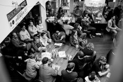 Attendees sitting at tables and listening to the opening remarks