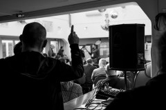 An attendee holds up his hand to indicate interest in a session