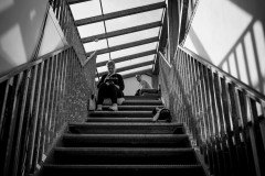 An attendee sits on the stairs to the balcony