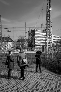 A group of photographers taking photos of train tracks and graffiti