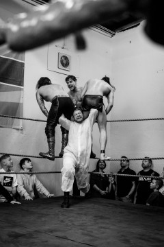 Sequence 4 of 5: Wrestler Matthias Bernstein is about to powerbomb his opponents Maggot and Prince Ahura