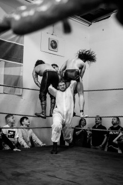 Sequence 2 of 5: Wrestler Matthias Bernstein is about to powerbomb his opponents Maggot and Prince Ahura