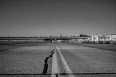 Tempelhof airport with people strolling towards it on the old tarmac