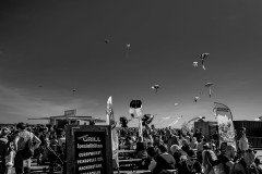 Kites in the sky above, people at tables having lunch below