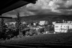 Houses, trees, mountains, seen from just under the roof