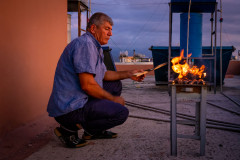 Preparing the grill for cooking on a rooftop