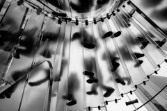 Shadows of people walking on a glas staircase, shot from below