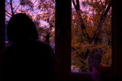 Ulya and Suvi looking out the window at a colorful sunrise