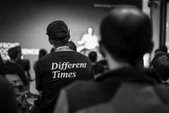 An attendee in the audience at Front Conference 2021 wears a t-shirt with a print on the back that say 