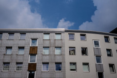 Row of houses beneath a sky with white clouds