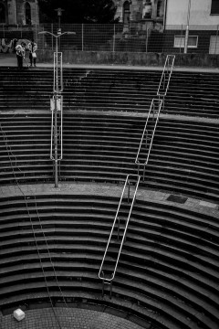 Two workers clean the stairs of a subway station in Essen