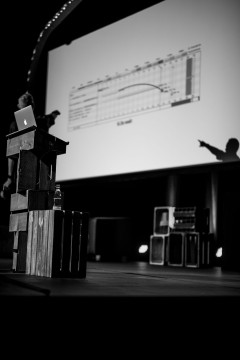A shadow of Harry Roberts pointing at the screen during his talk at beyond tellerrand 2021 in Düsseldorf