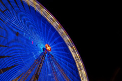 Ferris wheel in blurred motion, covered in blue light