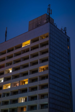 High rise residential building during twilight, with some of the aparments illuminated from inside
