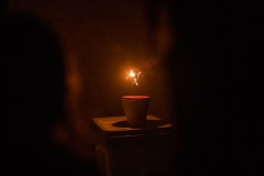 A lit sparkler in a flowerpot