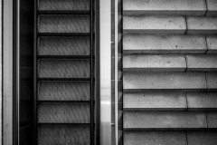 From above: escalator stairs next to regular stairs