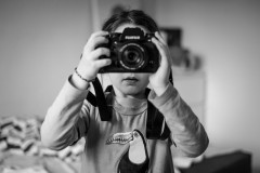 My dauther holding a camera in front of her face