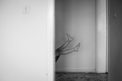 Legs of my daughter on a swing, seen through a door way