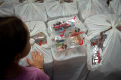 My daughter inspects the meals that will be distributed to school children in the area.