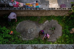 Image of my children and their grandma from above while they are gardening
