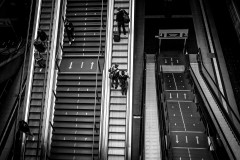 People going up and down escalators at the Berlin main station, photographed from above