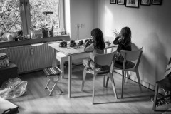 My daughters sitting at the kitchen table enjoying a meal