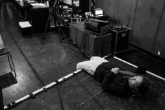 Marc Thiele laying on the stage at border:none 2023 in Nuremberg
