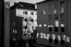 A play of light and shadow on the faces of the buildings across the street