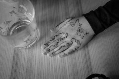 My daugthers drawn-on hand on the table next to a drinking glas