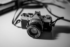 Monochrome photo of the Olympus OM-1 on my desk